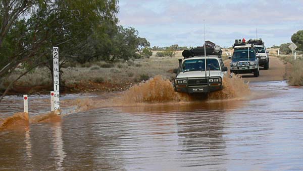 Convoy crossing flooded Diamantina Road, following explorers Burke and Wills